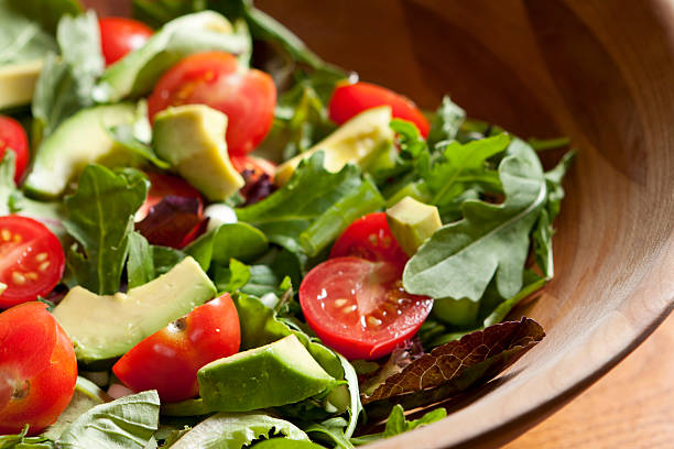 A garden salad with lettuce, avocado slices, and garden fresh tomatoes