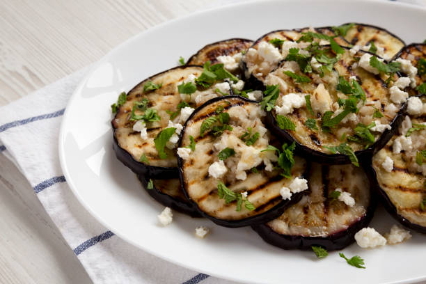 Homemade roasted Eggplant with Feta and Herbs on a white plate